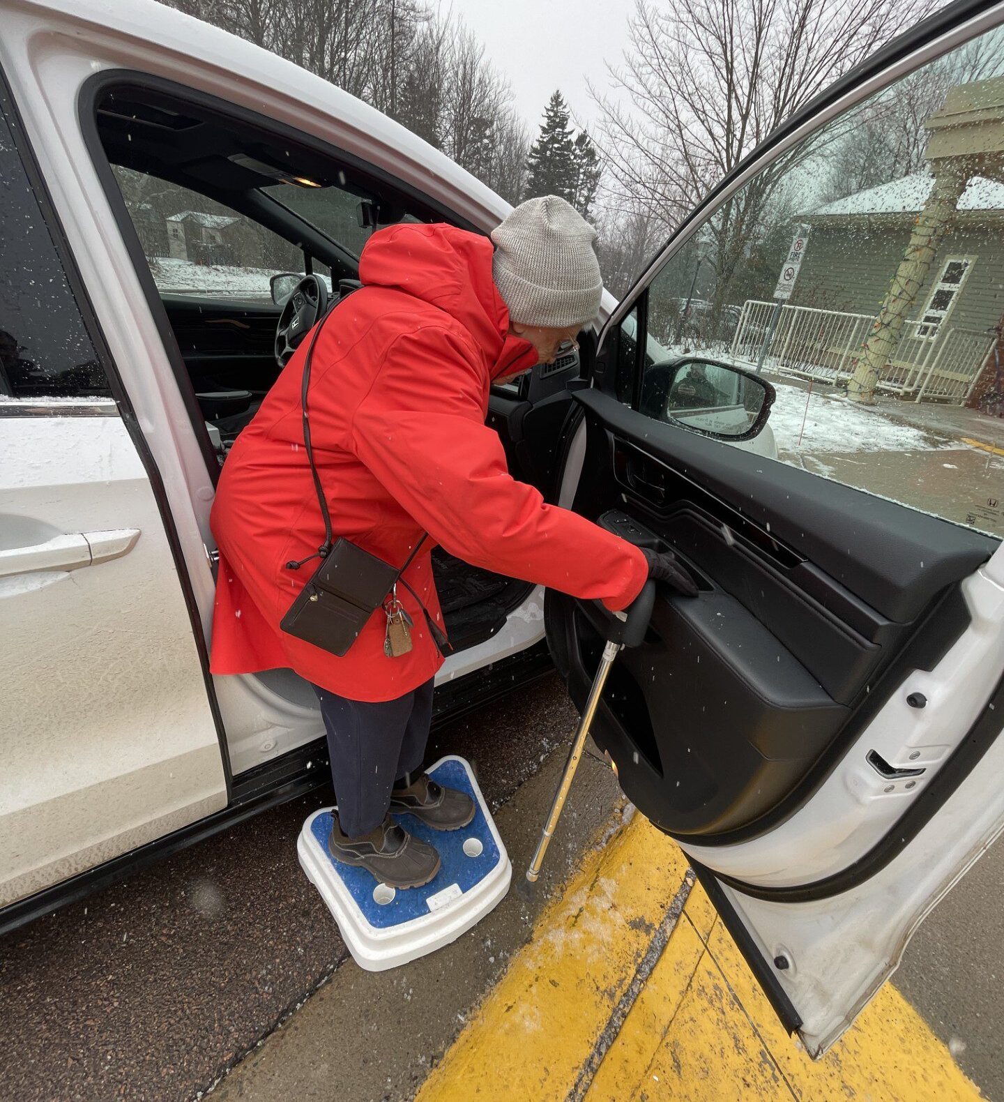 Elderly woman with cane leaving Roads to Sea senior shuttle by step